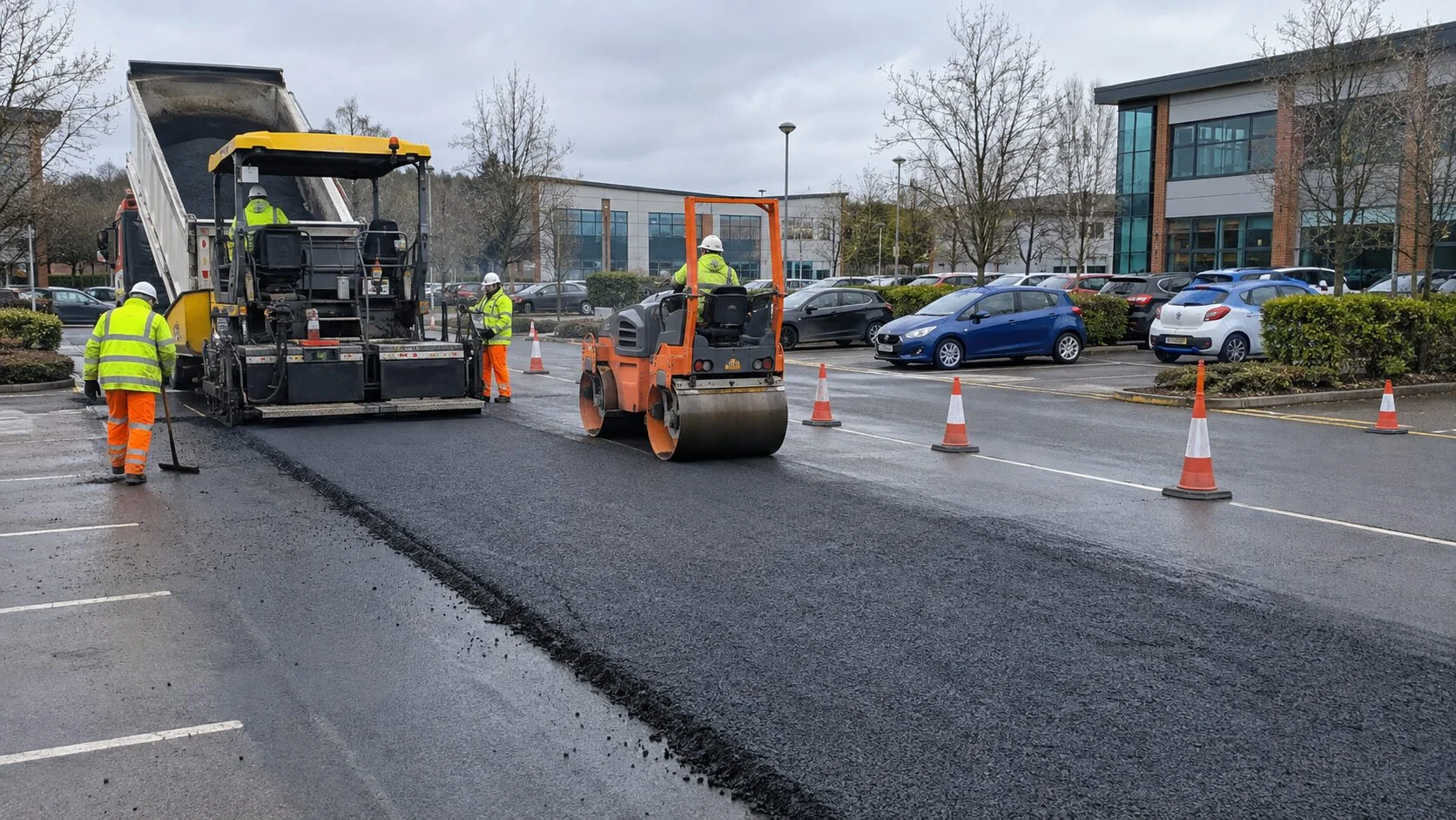 Tarmac overlay being installed in a live commercial car park